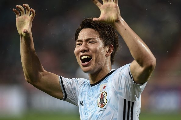 Japan football player Takuma Asano celebrates after scoring a goal during the 2018 FIFA World Cup qualifying match between Thailand and Japan in Ba...