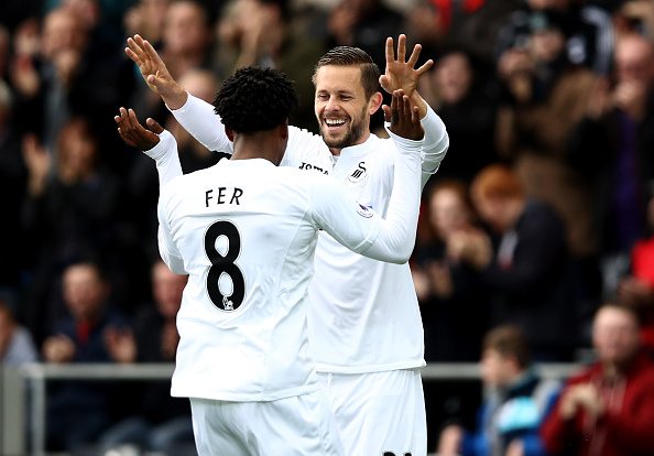 SWANSEA, WALES - OCTOBER 01: Leroy Fer of Swansea City (L) celebrates scoring his sides first goal with Gylfi Sigurdsson of Swansea City (R) during the Premier League match between Swansea City and Liverpool at Liberty Stadium on October 1, 2016 in Swansea, Wales. (Photo by Julian Finney/Getty Images)