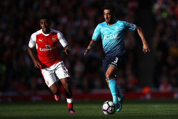 Iwobi explains what Mesut Ozil told him as he admits he's never happy with his performances 2 LONDON, ENGLAND - OCTOBER 15: Neil Taylor of Swansea City goes past Alex Iwobi of Arsenal during the Premier League match between Arsenal and Swansea City at Emirates Stadium on October 15, 2016 in London, England. (Photo by Julian Finney/Getty Images)