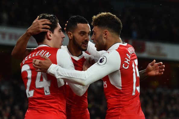 Theo Walcott announces retirement at 34 4 Arsenal's English midfielder Theo Walcott (C) celebrates with Arsenal's Spanish defender Hector Bellerin (L) and Arsenal's English midfielder Alex Oxlade-Chamberlain after scoring during the English Premier League football match between Arsenal and Stoke City at the Emirates Stadium in London on December 10, 2016. (Photo credit GLYN KIRK/AFP/Getty Images)