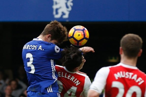 Chelsea's Spanish defender Marcos Alonso (L) rises above Arsenal's Spanish defender Hector Bellerin (C) to score the opening goal during the Englis...