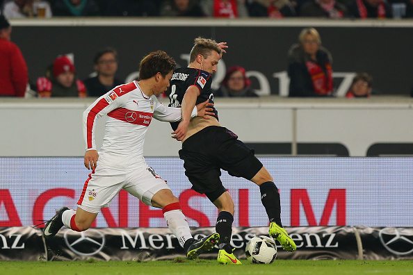 Asano (L) pictured in action against Dusseldorf, hunting tirelessly for the ball