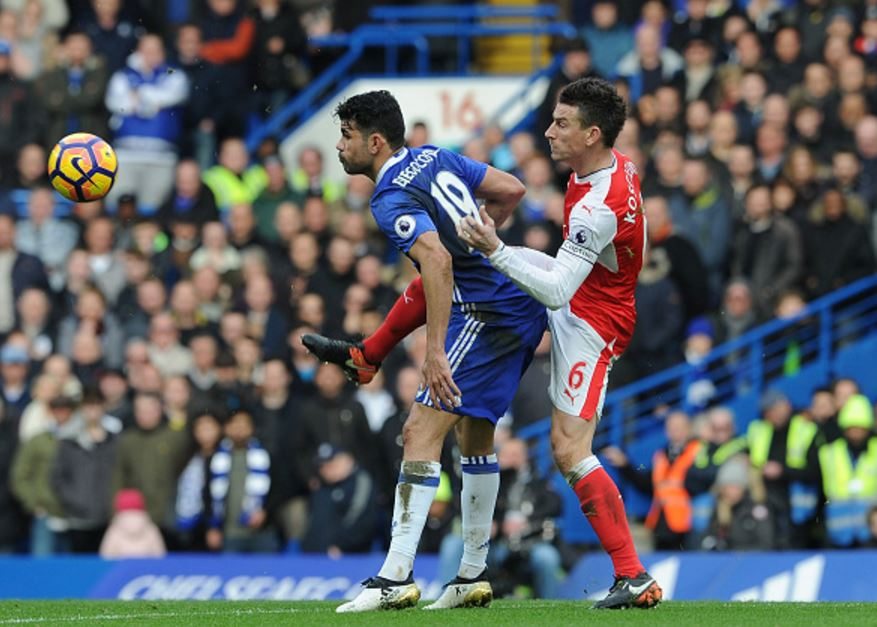 Koscielny (R) challenges Costa in a duel for possession during the Chelsea fixture
