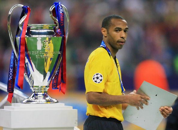 Saint-Denis, FRANCE: Arsenal's French forward and team captain Thierry Henry passes next to the trophy after the UEFA Champion's League final footb...