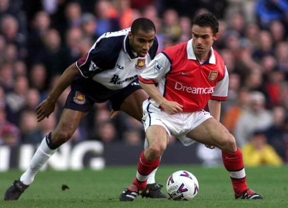 2 May 2000: Marc Overmars of Arsenal takes on Frederic Kanoute of West Ham during the match between Arsenal and West Ham United in the FA Carling P...