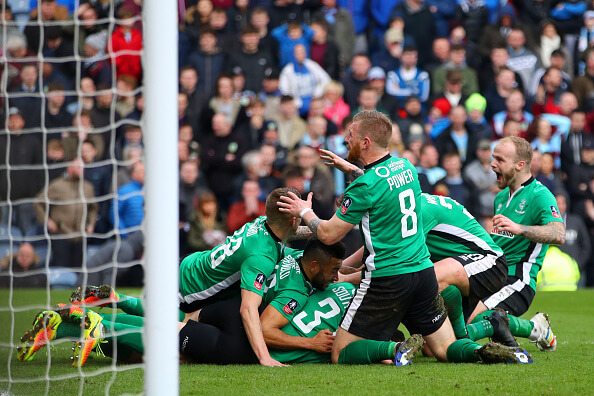 Raggett and his Lincoln teammates celebrate a last-gasp winner to progress into the last-eight