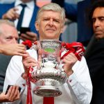 Arsenal's French manager Arsene Wenger smiles as he holds the FA Cup trophy after their win over Chelsea in the English FA Cup final football match between Arsenal and Chelsea at Wembley stadium in London on May 27, 2017. (ADRIAN DENNIS/AFP/Getty Images)