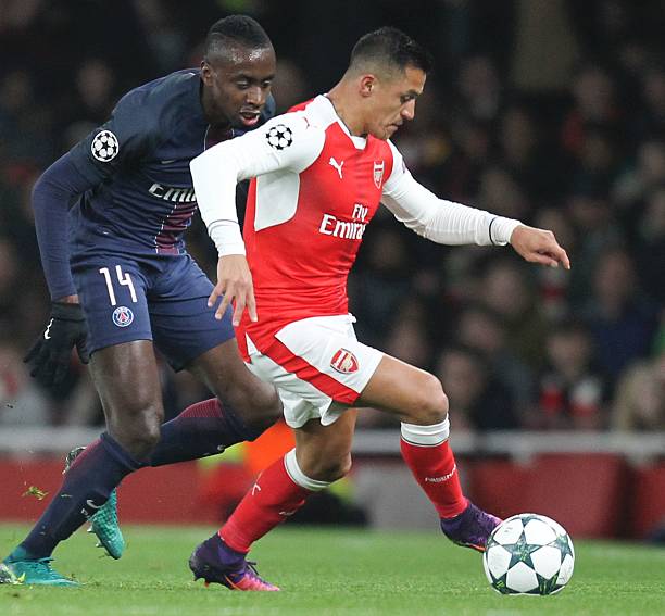 Arsenals Chilean striker Alexis Sanchez R dribbles by Paris Saint Germains French midfielder Blaise Matuidi L