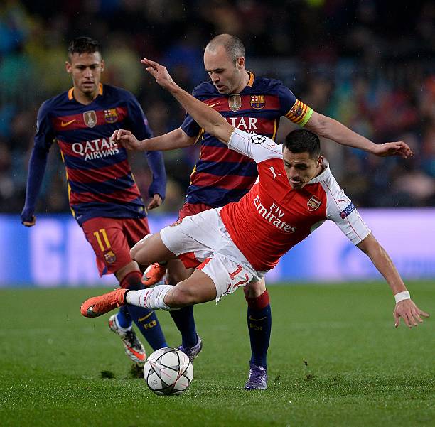 Barcelonas midfielder Andres Iniesta C vies with Arsenals Chilean forward Alexis Sanchez R next to Barcelonas Brazilian forward Neymar
