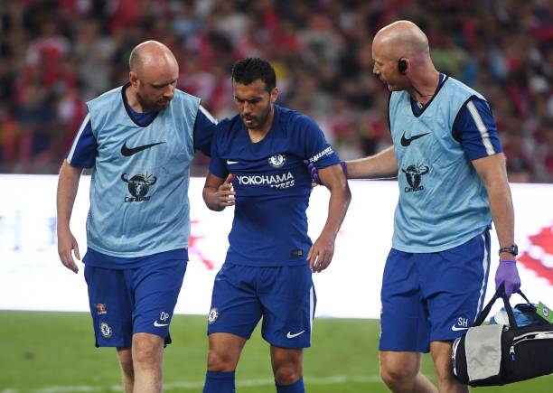 Chelseas Pedro C leaves the field after a collision with Arsenals David Ospina
