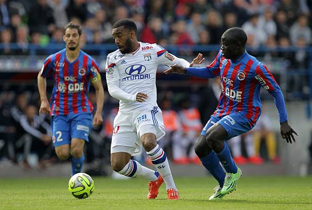 Lyons French forward Alexandre Lacazette L fights for the ball with Caens French midfielder Ngolo Kante