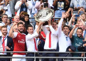LONDON, ENGLAND - AUGUST 06: (L-R) Calum Chambers, Olivier Giroud, Laurent Koscielny, Per Mertesacker, Gabriel and David Ospina of Arsenal lift the Community Shield after the match between Chelsea and Arsenal at Wembley Stadium on August 6, 2017 in London, England. (Photo by David Price/Arsenal FC via Getty Images)