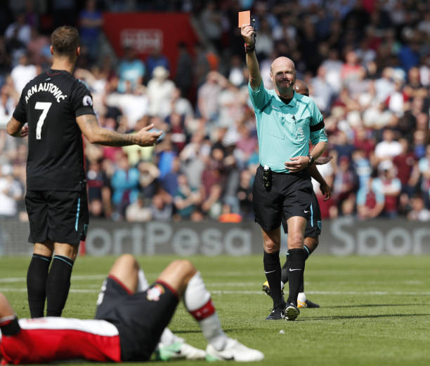West Ham Uniteds Austrian midfielder Marko Arnautovic L gestures as referee Lee Mason R gives him a red card