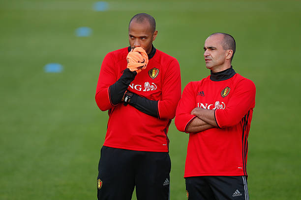 Belgium's assistant coach Thierry Henry (L) talks to Belgium's head coach Roberto Martinez during a training session in Tubize on October 3, 2016, ...