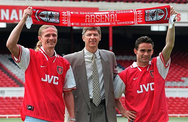 Arsenal football club manager Arsene Wenger (C) with the clubs' new signings, Emmanuel Petit (L) and Marc Overmars 17 June at Highbury Stadium in London. Petit was signed from AS Monaco and Overmars from Ajax. Picture: ADRIAN DENNIS/AFP/Getty Images