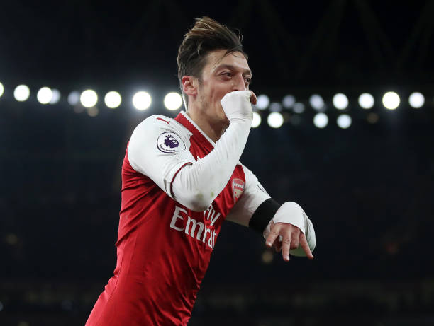 LONDON, ENGLAND - NOVEMBER 29: Mesut Ozil of Arsenal celebrates after scoring his sides fourth goal during the Premier League match between Arsenal...
