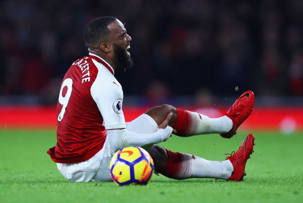 Alexandre Lacazette of Arsenal is injured during the Premier League match between Arsenal and Liverpool at Emirates Stadium on December 22, 2017 in...