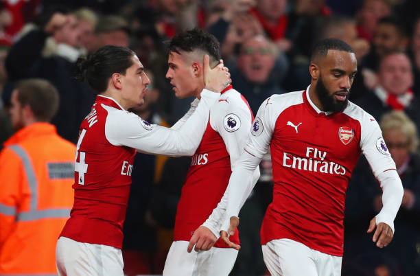 Granit Xhaka of Arsenal (C) celebrates as he scores their second goal with team mates Hector Bellerin and Alexandre Lacazette during the Premier Le...