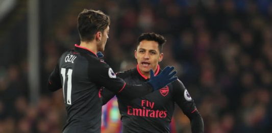 LONDON, ENGLAND - DECEMBER 28: Alexis Sanchez of Arsenal celebrates as he scores their second goal with Mesut Ozil during the Premier League match between Crystal Palace and Arsenal at Selhurst Park on December 28, 2017 in London, England. (Photo by Catherine Ivill/Getty Images)
