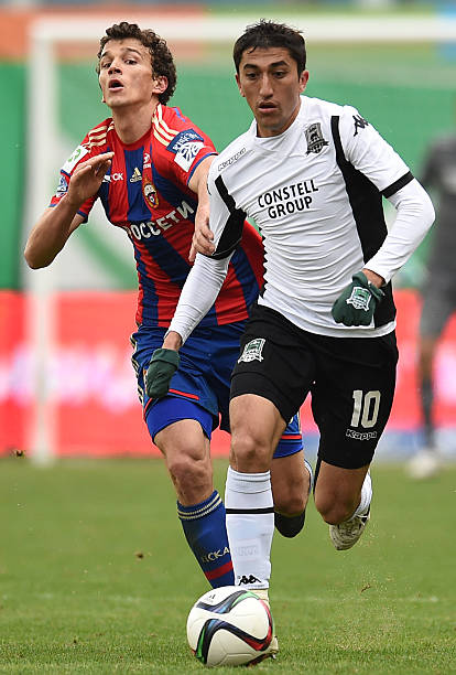 KHIMKI, RUSSIA - APRIL 19: Roman Eremenko (L) of PFC CSKA Moscow challenged by Odil Ahmedov of FC Krasnodar during the Russian Premier League match...