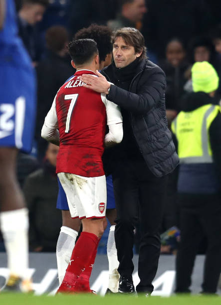 LONDON, ENGLAND - JANUARY 10: Alexis Sanchez of Arsenal speaks with Antonio Conte, Manager of Chelsea during the Carabao Cup Semi-Final First Leg m...