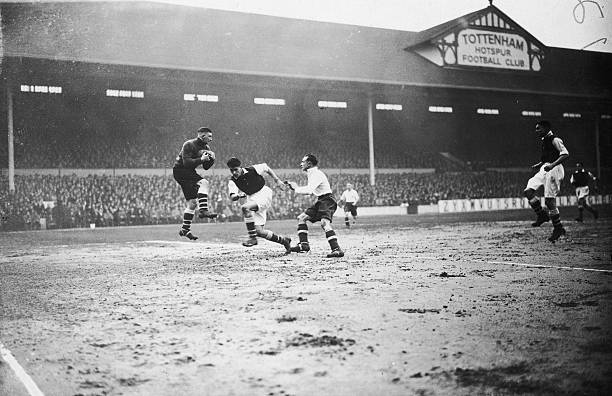 Arsenal goalkeeper Frank Moss makes a save from Tottenham striker George Hunt as defender Leslie Compton rushes in during a league match at White Hart Lane, 6th March 1935. Arsenal beat Spurs 6-0, their biggest ever victory in this fixture. (Photo by Topical Press Agency/Hulton Archive/Getty Images)