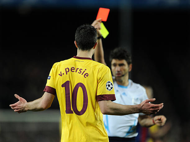 BARCELONA, SPAIN - MARCH 08: Robin van Persie of Arsenal reacts as referee Massimo Busacca shows his a red card during the UEFA Champions League ro...