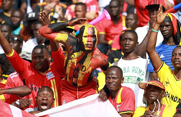 Uganda 'Cranes' team's fan painted with Uganda's national flag colors gestures as the 'Cranes' beat Congo Brazzaville during their 2018 World Cup q...