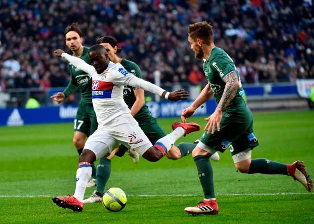 Lyon's French midfielder Tanguy Ndombele Alvaro (L) kicks the ball during the French L1 football match between Lyon (OL) and Saint-Etienne (ASSE) o...