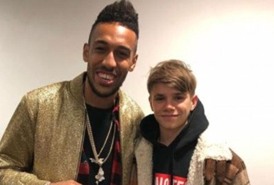 A younger Romeo Beckham attending an Arsenal match alongside Pierre-Emerick Aubameyang