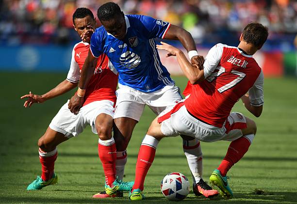 MLS All-Stars forward Didier Drogba (C) struggles to control the ball while holding onto Arsenal defender Krystian Bielik (R) during an MLS All-Star match at Avaya Stadium in San Jose, California on July 28, 2016. / AFP / JOSH EDELSON