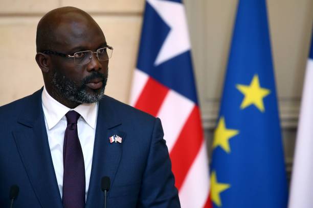 Liberian President George Weah speaks during a joint press conference with his French counterpart at the Elysee Palace in Paris on February 21, 2018. / AFP PHOTO / POOL / STEPHANE MAHE