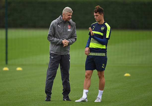 ST ALBANS, ENGLAND - SEPTEMBER 27: Manager Arsene Wenger of Arsenal talks to Granit Xhaka during an Arsenal training session ahead of the Champions League Group A match between Arsenal and Basel at London Colney on September 27, 2016 in St Albans, England. (Photo by Mike Hewitt/Getty Images)