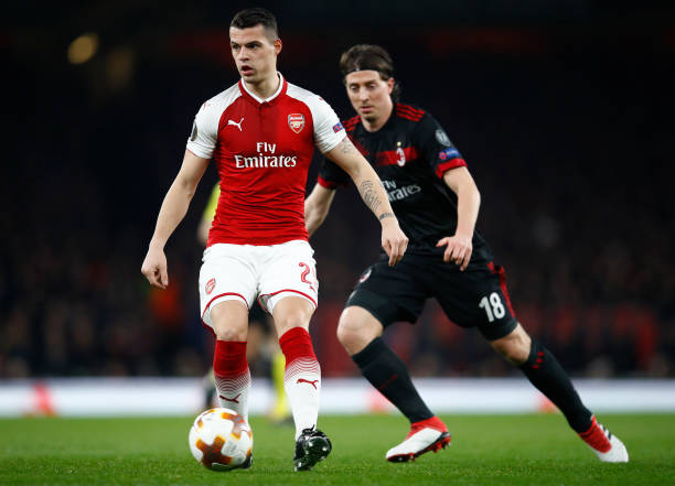 Xhaka continues to impress as Welbeck steals the headlines: Player ratings v Milan 3 LONDON, ENGLAND - MARCH 15: Granit Xhaka of Arsenal keeps the ball from Riccardo Montolivo of AC Milan during the UEFA Europa League Round of 16 Second Leg match between Arsenal and AC Milan at Emirates Stadium on March 15, 2018 in London, England. (Photo by Julian Finney/Getty Images)