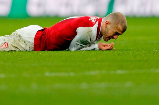 Arsenal's English midfielder Jack Wilshere reacts after picking up an injury during the English League Cup final football match between Manchester ...
