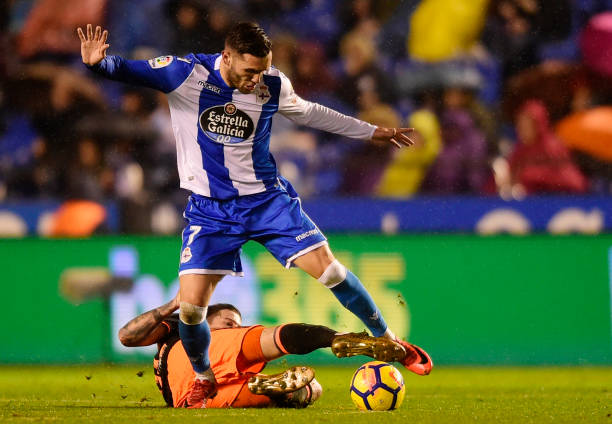 Deportivo La Coruna's Spanish forward Lucas Perez (top) vies with Valencia's Spanish forward Santi Mina during the Spanish league football match be...