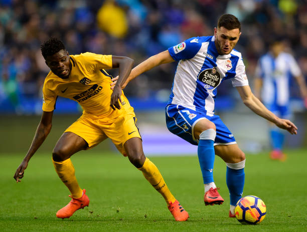 Deportivo La Coruna's spanish forward Lucas Perez (R) vies with Atletico Madrid's Ghanaian midfielder Thomas Partey during the Spanish league footb...