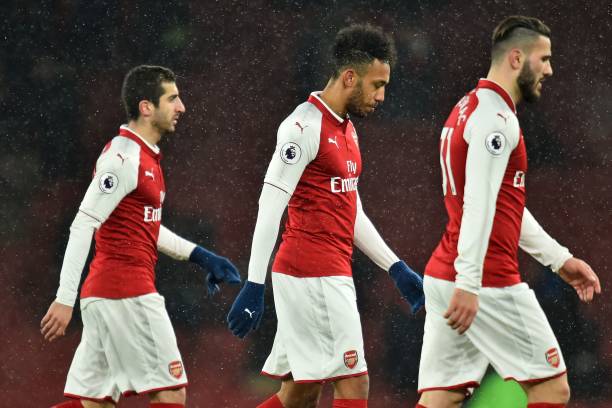 Arsenal's Armenian midfielder Henrikh Mkhitaryan (L), Arsenal's Gabonese striker Pierre-Emerick Aubameyang (C) and Arsenal's German-born Bosnian defender Sead Kolasinac (R) leave the pitch after the English Premier League football match between Arsenal and Manchester City at the Emirates Stadium in London on March 1, 2018. Manchester City won the game 3-0. / AFP PHOTO / Glyn KIRK /
