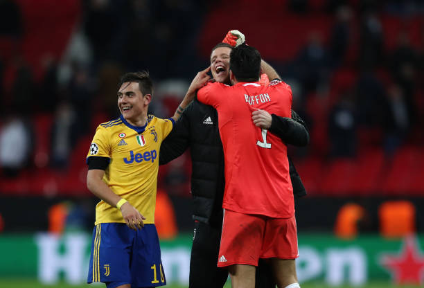 LONDON, ENGLAND - MARCH 07: Paulo Dybala and Gianluigi Buffon of Juventus celebrate with Wojciech Szczesny of Juventus after the UEFA Champions Lea...