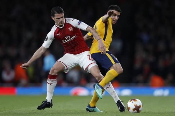 Exclusive: Emmanuel Petit insists Xhaka must improve his game in these 3 areas 2 rsenal's Swiss midfielder Granit Xhaka (L) vies with Atletico Madrid's Argentinian striker Angel Correa during the UEFA Europa League first leg semi-final football match between Arsenal and Atletico Madrid at the Emirates Stadium in London on April 26, 2018. (Photo by Adrian DENNIS / AFP)
