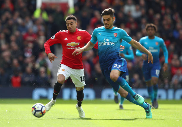 MANCHESTER, ENGLAND - APRIL 29: Konstantinos Mavropanos of Arsenal is challenged by Jesse Lingard of Manchester United during the Premier League ma...
