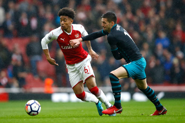LONDON, ENGLAND - APRIL 08: Reiss Nelson of Arsenal and Dusan Tadic of Southampton battle for possession during the Premier League match between Ar...