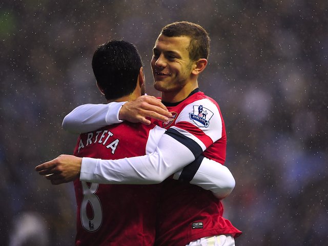Arsenal's Mikel Arteta celebrates scoring their first goal of the game from the penalty spot with team-mate Jack Wilshere (right)