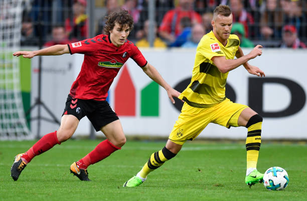 Freiburg's Turkish defender Caglar Soyuncu (L) and Dortmund's Ukrainian forward Andrey Yarmolenko vie for the ball during German first division Bun...