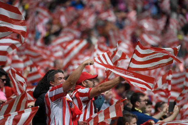 Atletico fans wave flags before the Spanish league footbal match between Club Atletico de Madrid and Levante UD at the Wanda Metropolitano stadium ...
