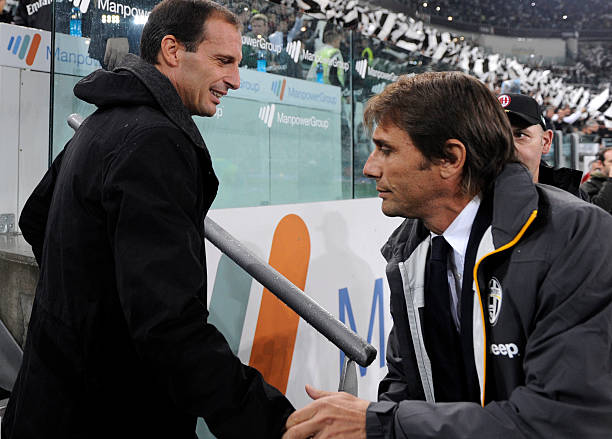 AC Milan's coach Massimiliano Allegri (L) and Juventus' coach Antonio Conte are pictured during the Serie A football match Juventus vs AC Milan on October 6, 2013 in Turin. AFP PHOTO / ALBERTO LINGRIA