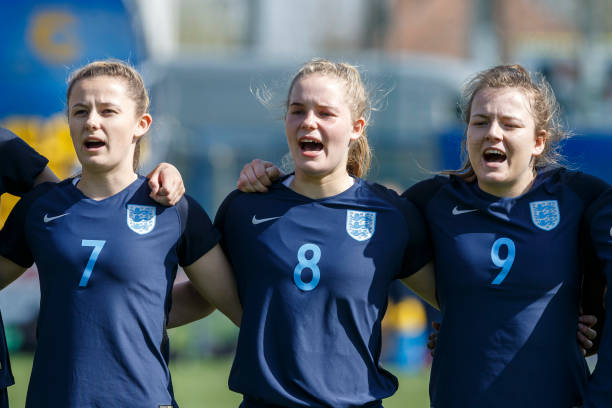 DUNAJSKA LUZNA, SLOVAKIA - APRIL 09: Hannah Cain, Constance Schofield and Lauren Hemp (L-R) of England line up during the national anthem prior to the UEFA Women's Under19 Elite Round match between England and Germany on April 9, 2018 in Dunajska Luzna, Slovakia. (Photo by Christian Hofer/Bongarts/Getty Images)