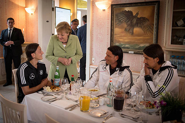 Angela Merkel defends 'thoughtless' Mesut Ozil who is affected by whistles 2 SOPOT, POLAND - JUNE 06: In this photo provided by the German Government Press Office (BPA), German Chancellor Angela Merkel talks to German National Team players Mesut Oezil (L), Tim Wiese (C) and Sami Khedira during a shared dinner at the Euro 2012 Team Hotel on June 6, 2012 in Sopot, Poland. (Photo by Guido Bergmann/Bundesregierung-Pool via Getty Images)