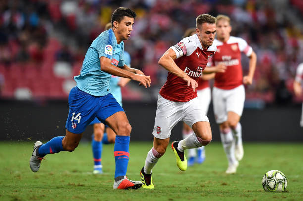 Unai Emery confirms Arsenal captaincy plan 2 SINGAPORE - JULY 26: Rodri #14 of Atletico Madrid and Aaron Ramsey #8 of Arsenal compete for the ball during the International Champions Cup 2018 match between Club Atletico de Madrid and Arsenal at the National Stadium on July 26, 2018 in Singapore. (Photo by Thananuwat Srirasant/Getty Images for ICC)
