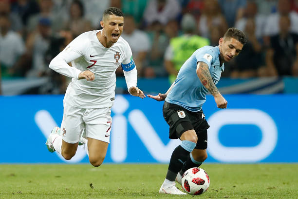 Uruguay's midfielder Lucas Torreira (R) vies for the ball with Portugal's forward Cristiano Ronaldo during the Russia 2018 World Cup round of 16 fo...